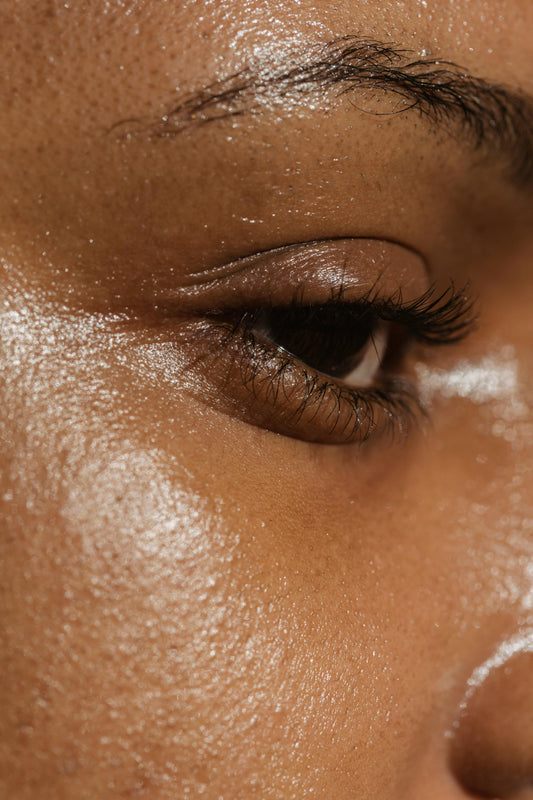 Woman applying hydrating setting spray showing dewy glowing skin with long-lasting makeup